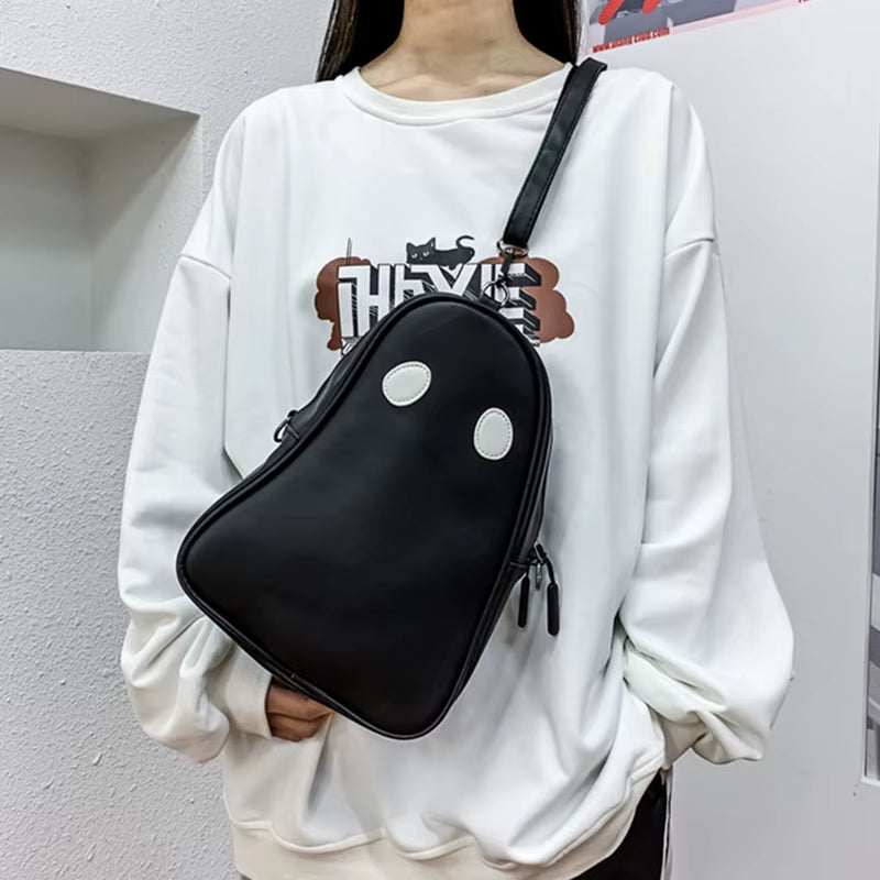 Halloween cartoon ghost shaped black crossbody bag with white eyes, styled with casual white sweatshirt