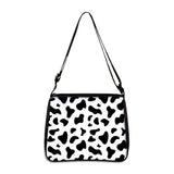 Cow print small shoulder bag with adjustable strap and black and white pattern