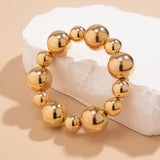 Goth vintage big CCB chain bracelet with large gold beads on beige background