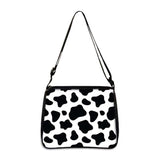 Cow print small shoulder bag with black and white pattern and adjustable strap