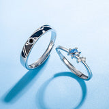 Dream Planet Couple Rings set with sterling silver and gemstone details on a blue background