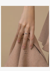 silver Dream Planet Couple Rings on hand with beige fabric background