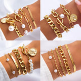 Set of gold color imitation pearl chain bracelets with coin and toggle clasp details on wrist