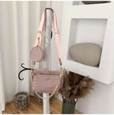 Vintage crocodile pattern women shoulder bag with chain and wide strap in pink tone hanging on wooden stand