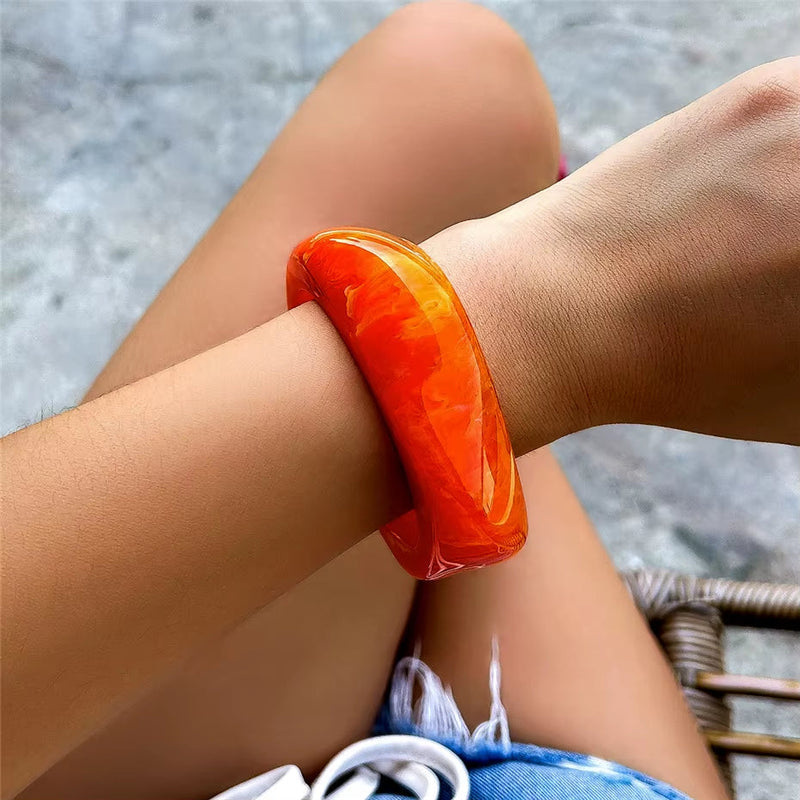 Vintage colorful irregular acrylic resin bracelet in transparent brown orange worn on wrist