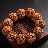 Close-up of a natural brown Fashion Rudraksha Beads Bracelet on a wooden decorative box