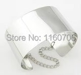 Silver wide cuff bracelet with chain detail on white background