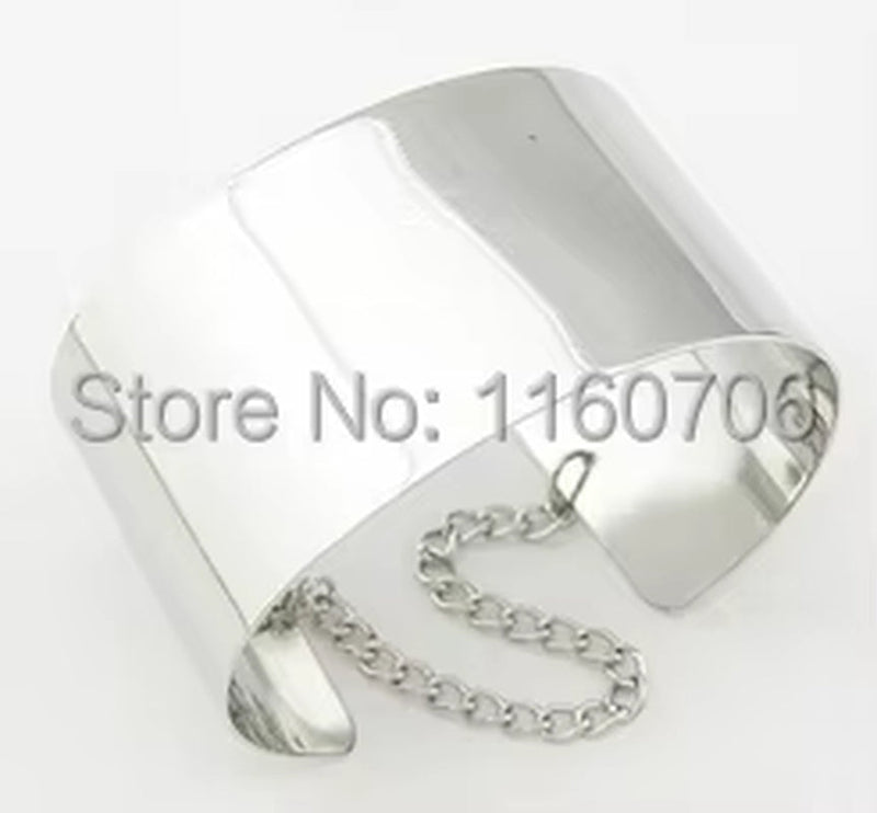 Silver wide cuff bracelet with chain detail on white background
