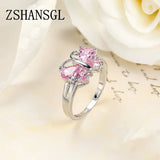 Silver butterfly ring with pink gemstones in sterling silver band