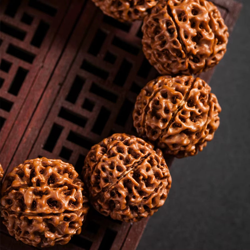 Close-up of fashion rudraksha beads bracelet on wooden surface