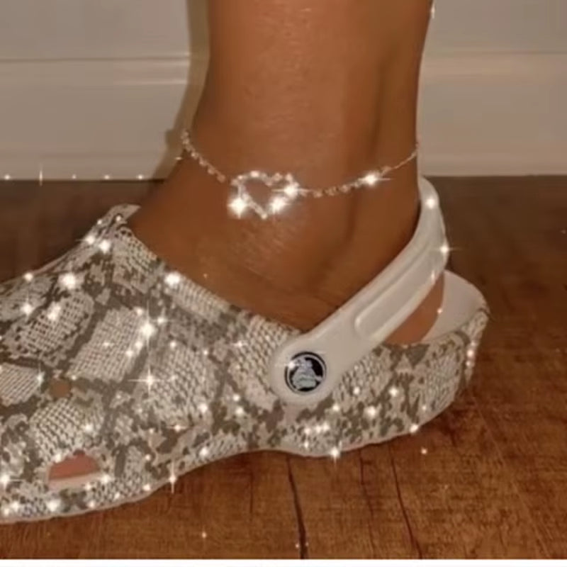 Sparkling rhinestone anklet on foot wearing patterned sandal beach accessories