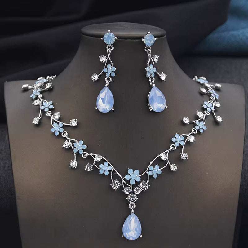 Rhinestone water drop necklace and earrings set with blue floral crystal design on silver metal