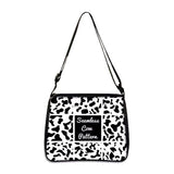 Cow print small shoulder bag with seamless black and white pattern and adjustable strap