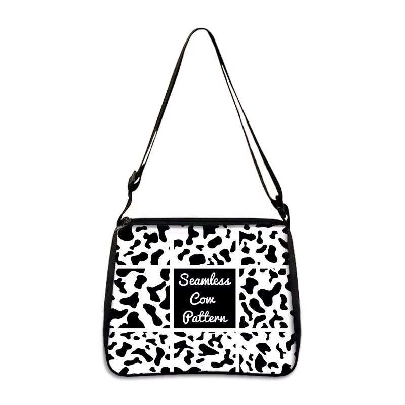 Cow print small shoulder bag with seamless black and white pattern and adjustable strap