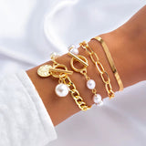 Imitation pearl chain gold bracelets and bangles set on wrist