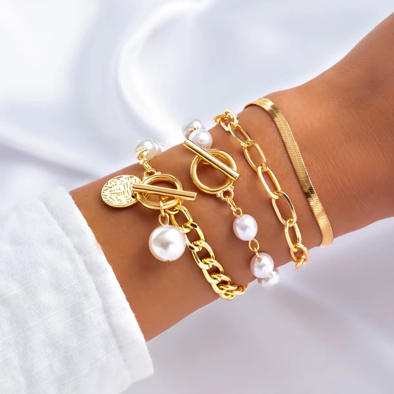 Imitation pearl chain gold bracelets and bangles set on wrist