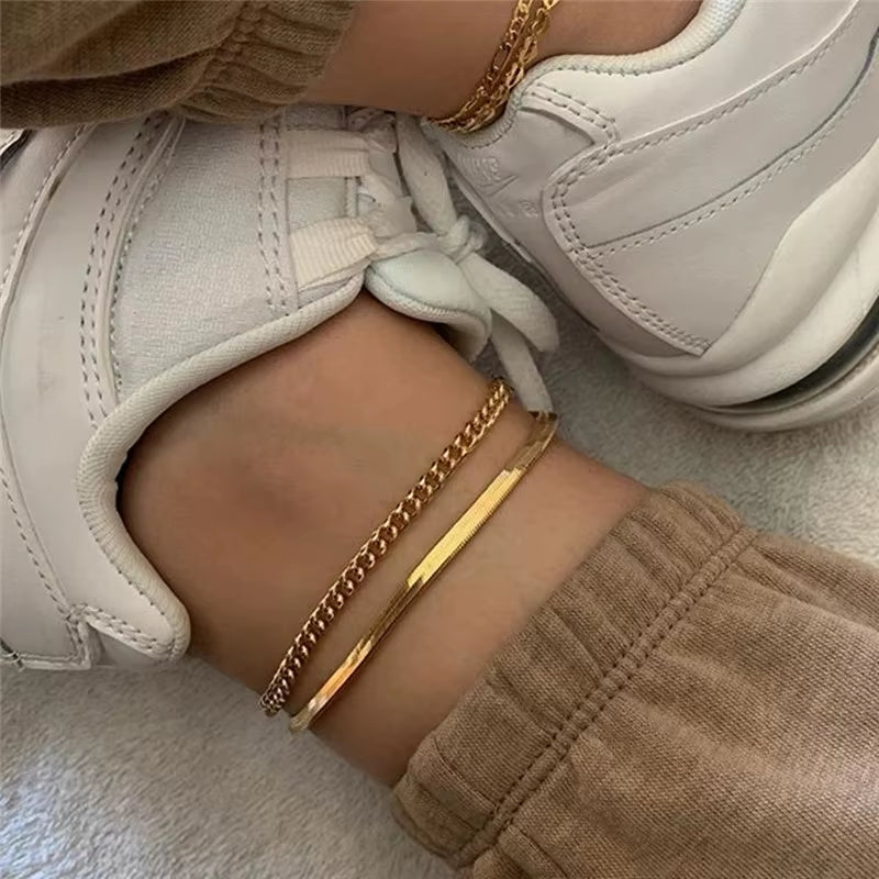 316L stainless steel gold-tone anklets worn with white sneakers and brown pants