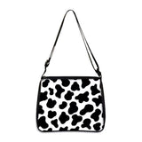 Cow print small shoulder bag with adjustable strap and black and white pattern