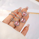 Fashion Heart Zircon pink heart-shaped earrings with silver rhinestone accents on hand