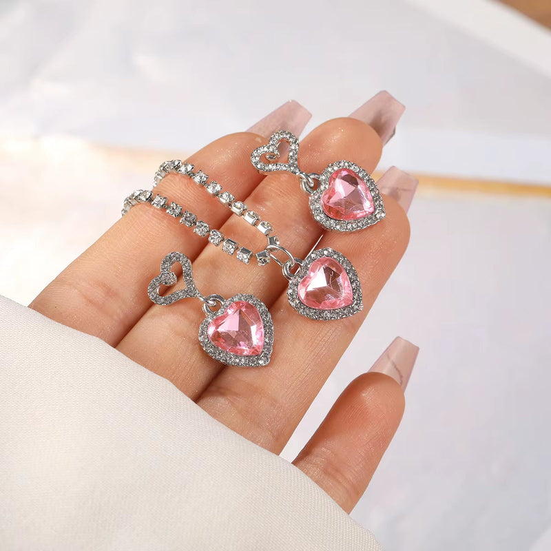 Fashion Heart Zircon pink heart-shaped earrings with silver rhinestone accents on hand