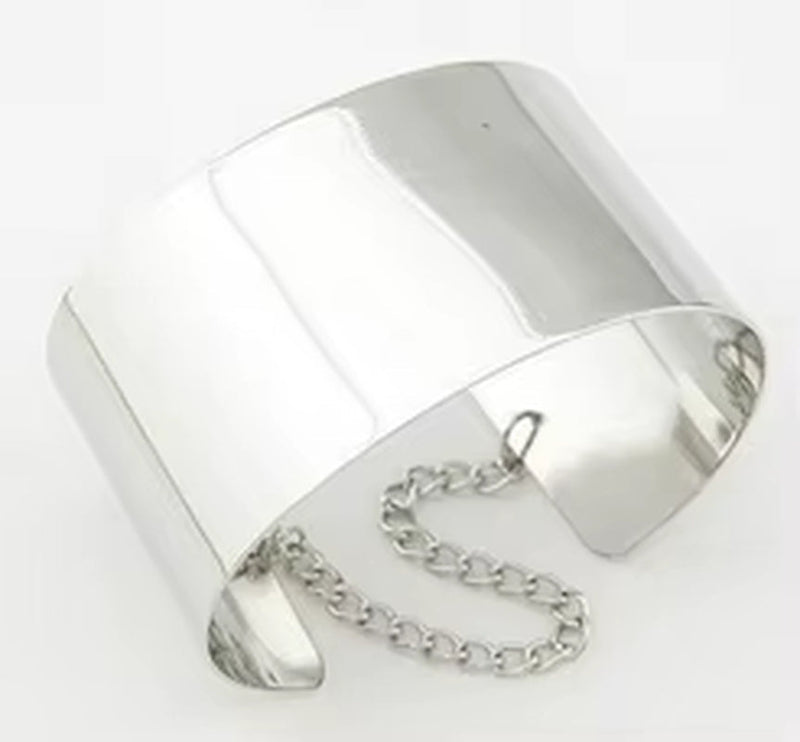 Shiny metallic silver chained cuff bracelet with smooth wide band and attached chain clasp