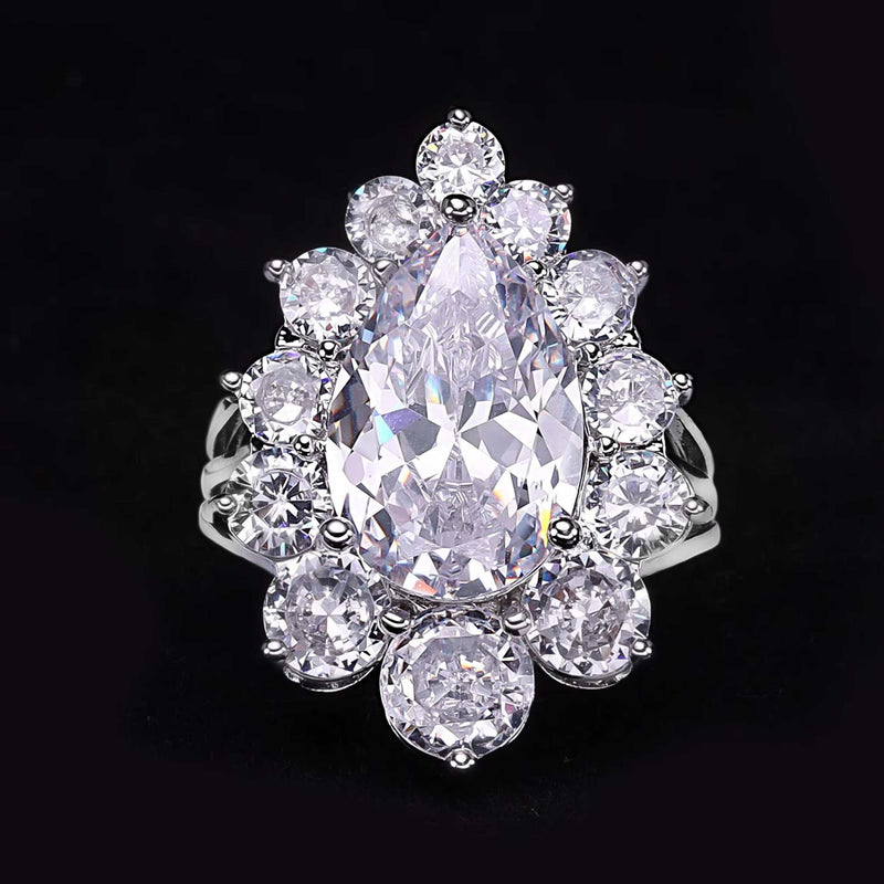 Cubic Zirconia Tassel Drop ring with pear-shaped center stone and surrounding round crystals on silver band