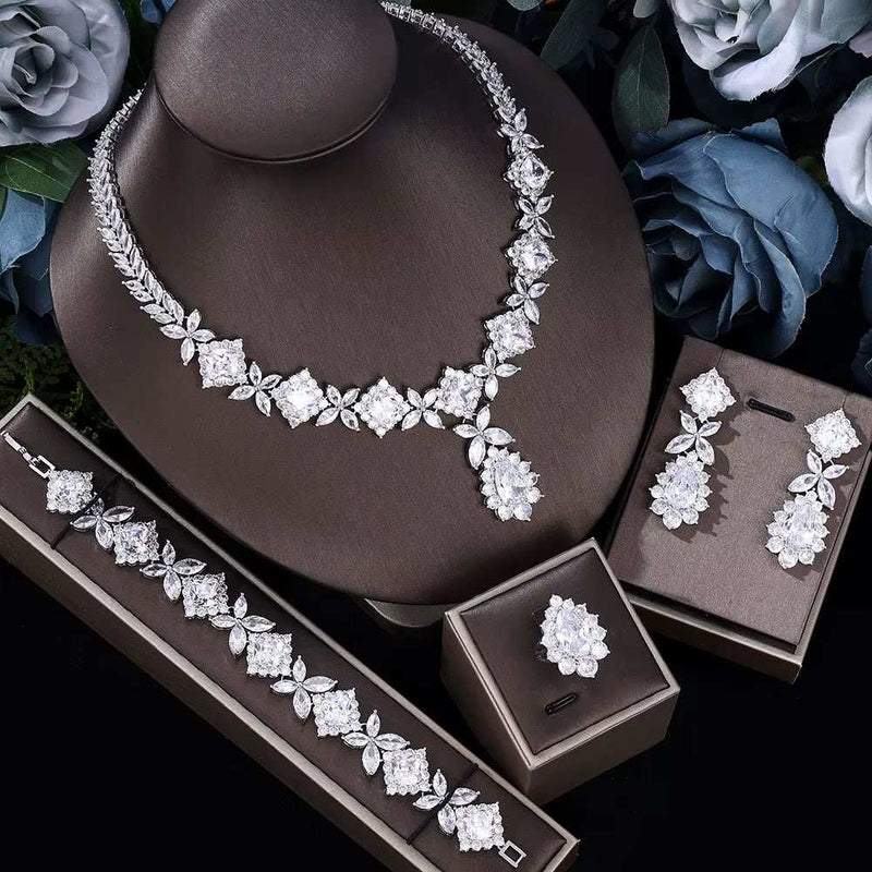 Cubic zirconia tassel drop bridal jewelry set with necklace, earrings, ring, and bracelet in silver tone
