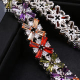 Luxury bracelet with colorful crystal flower charms and silver detailing on black background
