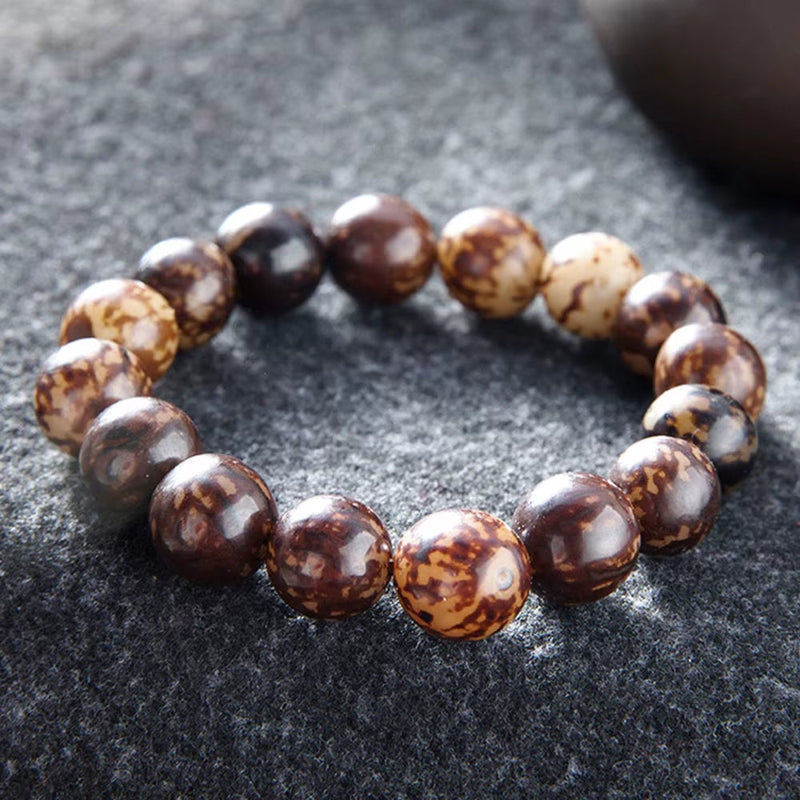 Fashion Rudraksha beads bracelet with natural brown and beige round beads on gray background