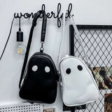 Halloween cartoon ghost themed black and white backpacks hanging on wall hooks with modern decor background