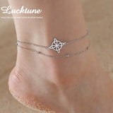 Silver stainless steel knot pendant anklet on ankle with chain design