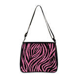 Small shoulder bag with pink and black zebra print design and adjustable strap