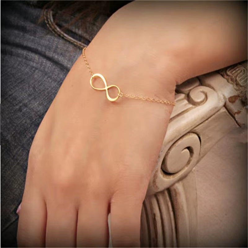 Golden silver color infinity bracelet on wrist with number 8 charm for women fashion jewelry gift