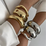 Punk Vintage Irregular chunky glossy gold and silver cuff bangles on wrists