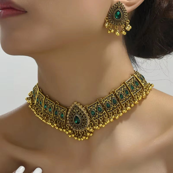 Vintage jewelry set featuring gold-toned choker necklace and matching earrings with green stone accents