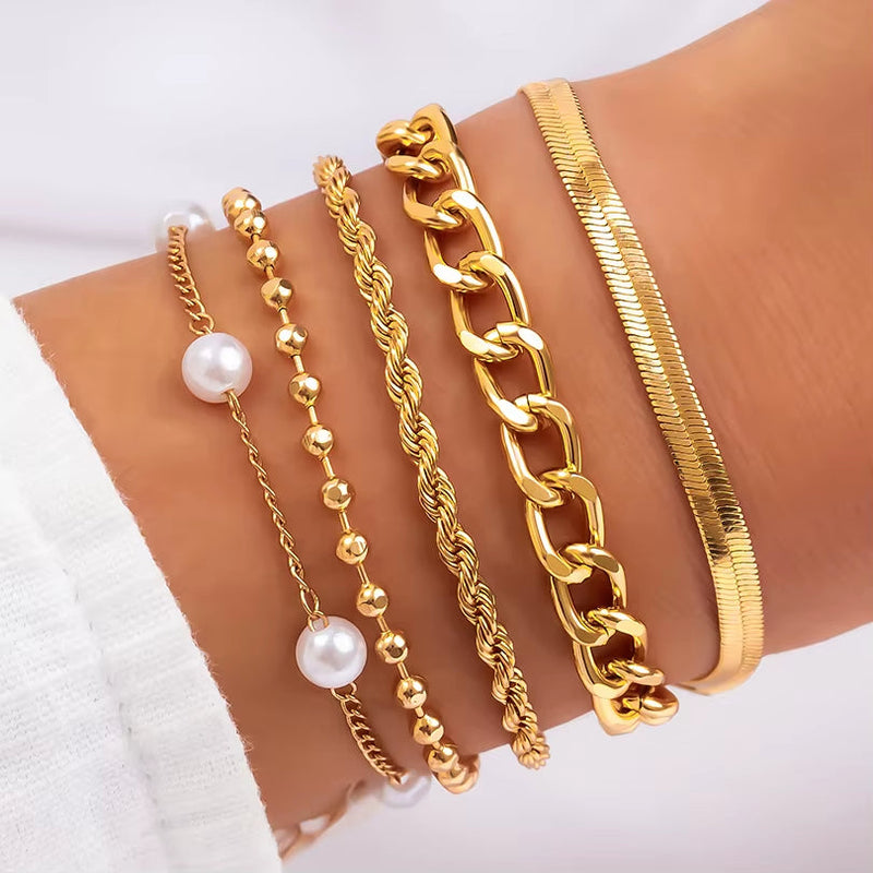 set of gold color imitation pearl chain bracelets and bangles on wrist