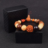 Nature Bodhi 18 Style Beads Bracelet with natural Rudraksha beads in varied earthy tones on black textured box