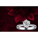 Romantic wedding ring with cubic zirconia on sterling silver band against red floral background