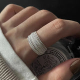 Close-up of hand wearing a silver textured fidget spinner ring on the finger