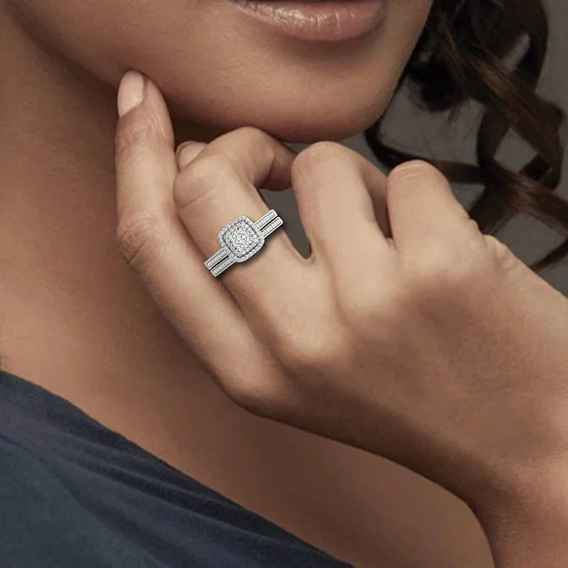 Close-up of a woman wearing a white gold plated moissanite ring set with white D color stones on her finger