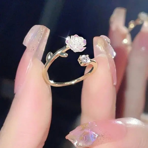 Delicate gold pink romantic flower ring with a rose design and small zircon detail on manicured nails
