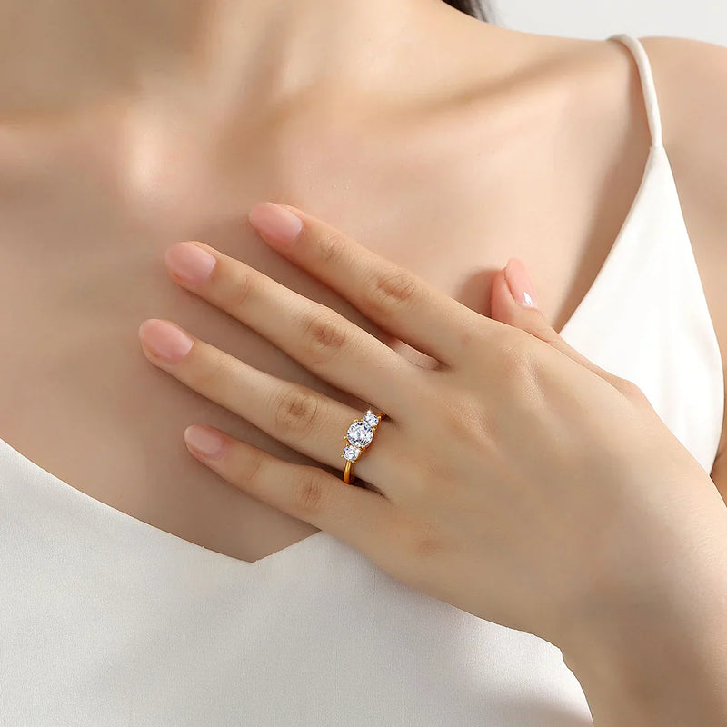Elegant 18K gold ring with natural white moissanite stones on woman's hand