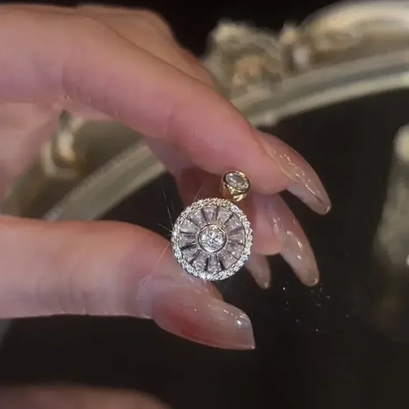 Close-up of a hand holding a sparkling fidget spinner ring with clear gemstones