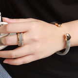 Vintage stainless steel mesh bracelet with gold heart accents on wrist