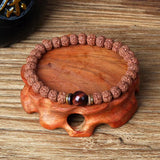 Royal Green Tiger Eye Vajra beaded Rudraksha meditation bracelet on wooden display