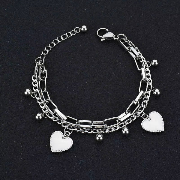 Nextvance Chain Link stainless steel heart charm bracelet for women on black background