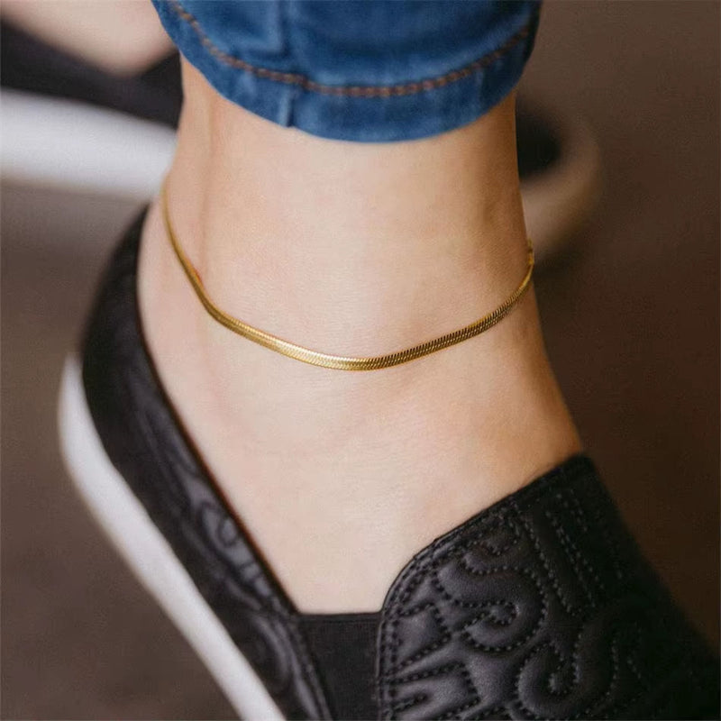 316L stainless steel gold anklet on ankle with black shoe and blue jeans