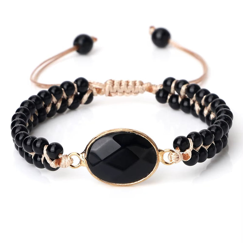 Adjustable black onyx natural stone beads bracelet with gold oval centerpiece and braided cord design