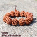 Fashion Rudraksha beads bracelet with natural 6 Mukhi rudraksha beads on grey stone background