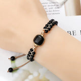 Black natural stone beads bracelet with adjustable cord on wrist